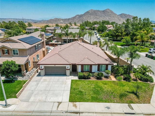 26946 Shelter Cove Ct, Menifee, CA 92585 - view of front of property featuring an attached garage, stucco siding, driveway, a tiled roof, and a residential view