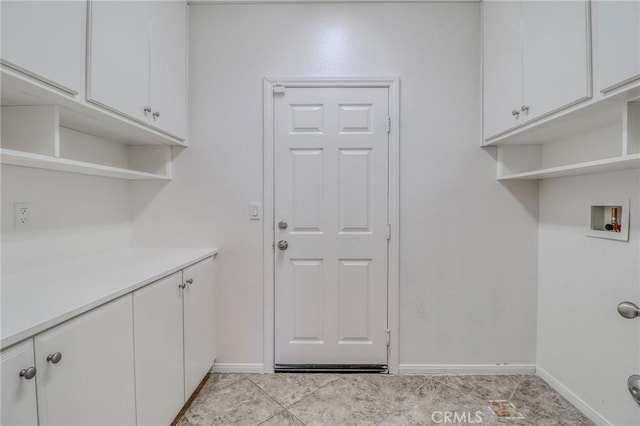 26946 Shelter Cove Ct, Menifee, CA 92585 - washroom with cabinet space, washer hookup, and light tile patterned floors