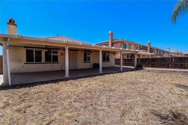 26946 Shelter Cove Ct, Menifee, CA 92585 - rear view of property featuring ceiling fan, stucco siding, a patio area, and a chimney