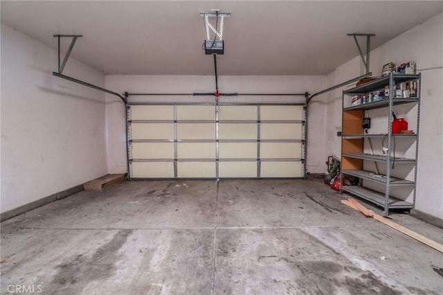 26946 Shelter Cove Ct, Menifee, CA 92585 - garage featuring a garage door opener and baseboards
