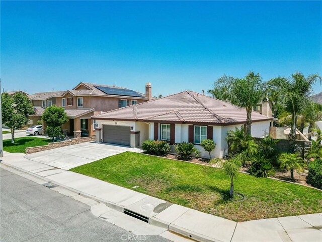 26946 Shelter Cove Ct, Menifee, CA 92585 - view of front of property featuring an attached garage, stucco siding, a front yard, and driveway