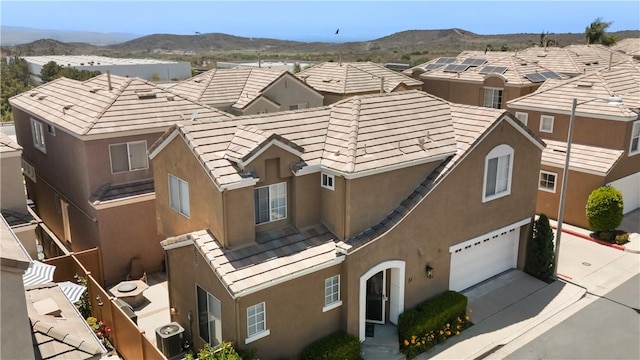 51 Rue Monet, Lake Forest, CA 92610 - view of building exterior with an attached garage, a mountain view, and concrete driveway