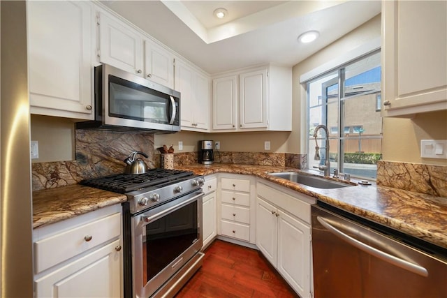 51 Rue Monet, Lake Forest, CA 92610 - kitchen with appliances with stainless steel finishes, white cabinets, dark wood-type flooring, recessed lighting, and light stone countertops