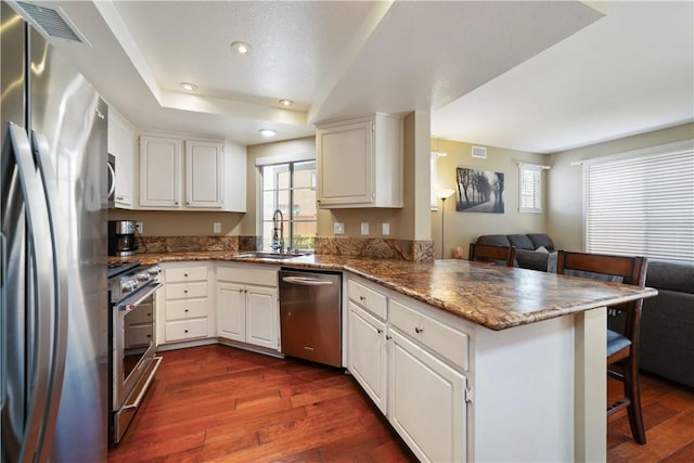 51 Rue Monet, Lake Forest, CA 92610 - kitchen with stainless steel appliances, a peninsula, plenty of natural light, open floor plan, and recessed lighting