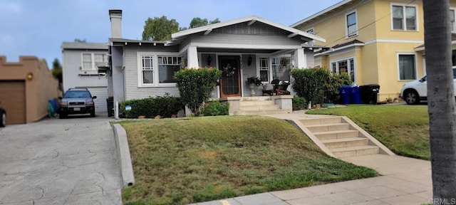 1320 Granada Ave, San Diego, CA 92102 - view of front of home featuring a front yard, concrete driveway, and a chimney