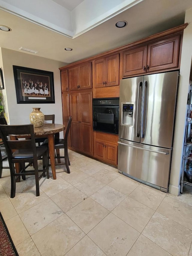 1320 Granada Ave, San Diego, CA 92102 - kitchen with stainless steel fridge, black oven, light tile patterned floors, and recessed lighting