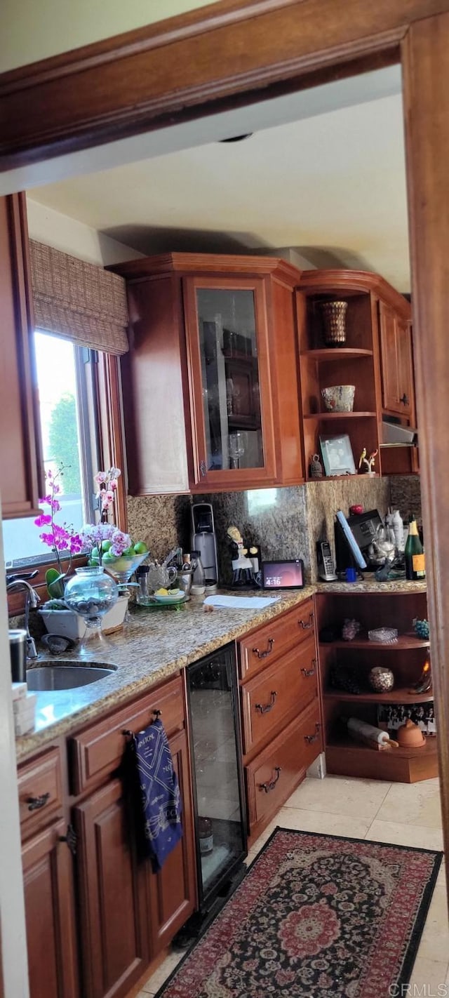 1320 Granada Ave, San Diego, CA 92102 - kitchen featuring beverage cooler, open shelves, light stone countertops, tasteful backsplash, and glass insert cabinets