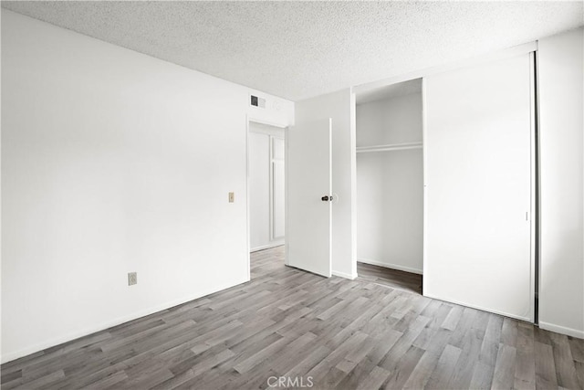 2536 Bryn Mawr Ln, Riverside, CA 92507 - unfurnished bedroom with wood finished floors, a textured ceiling, and a closet