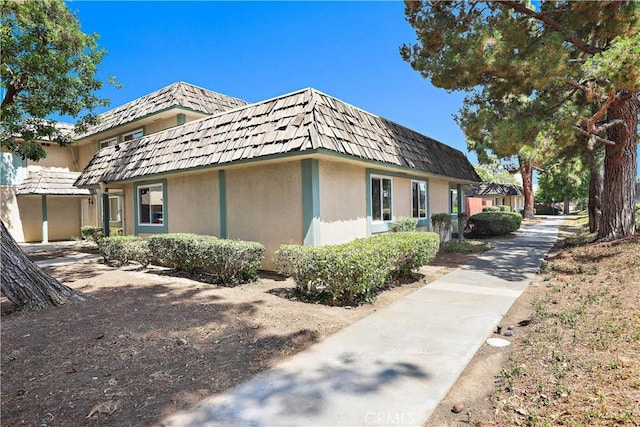 2536 Bryn Mawr Ln, Riverside, CA 92507 - view of side of home featuring mansard roof and stucco siding