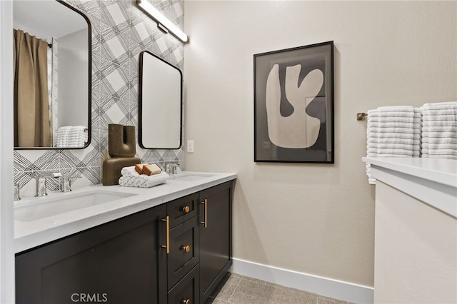 19011 Main St Unit 113, Huntington Beach, CA 92648 - bathroom featuring baseboards and double vanity