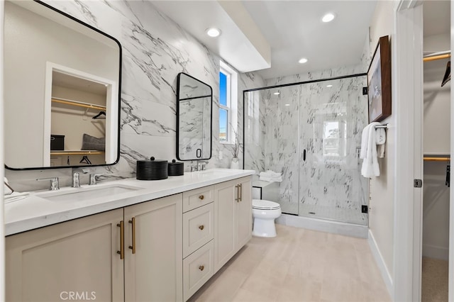 19011 Main St Unit 113, Huntington Beach, CA 92648 - bathroom featuring a spacious closet, a marble finish shower, recessed lighting, and tile walls