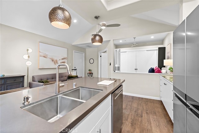 1046 Calle Del Cerro Unit 412, San Clemente, CA 92672 - kitchen featuring stainless steel appliances, open floor plan, vaulted ceiling, dark wood-style flooring, and white cabinetry