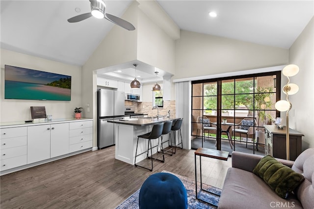1046 Calle Del Cerro Unit 412, San Clemente, CA 92672 - living area with high vaulted ceiling, dark wood-type flooring, ceiling fan, and recessed lighting