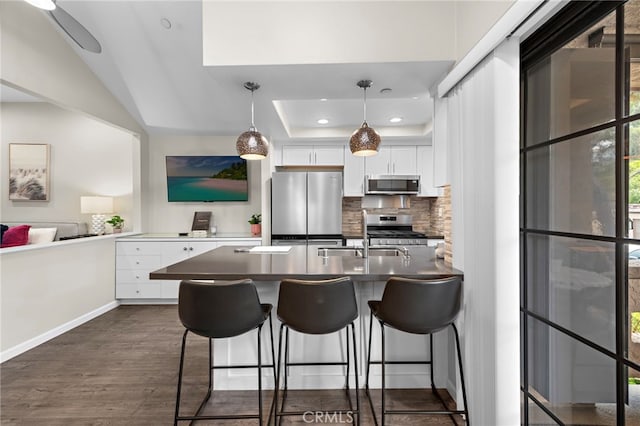 1046 Calle Del Cerro Unit 412, San Clemente, CA 92672 - kitchen featuring appliances with stainless steel finishes, backsplash, white cabinetry, a kitchen breakfast bar, and recessed lighting