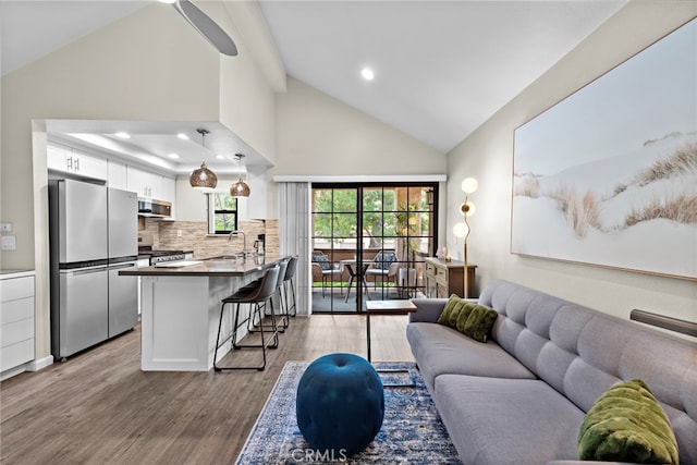 1046 Calle Del Cerro Unit 412, San Clemente, CA 92672 - living room featuring wood finished floors, recessed lighting, and high vaulted ceiling