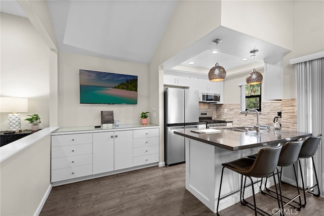 1046 Calle Del Cerro Unit 412, San Clemente, CA 92672 - kitchen featuring stainless steel appliances, dark wood finished floors, white cabinetry, backsplash, and recessed lighting