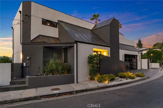 15125 Rayneta Dr, Sherman Oaks, CA 91403 - contemporary home with a standing seam roof, a metal roof, stucco siding, and a garage