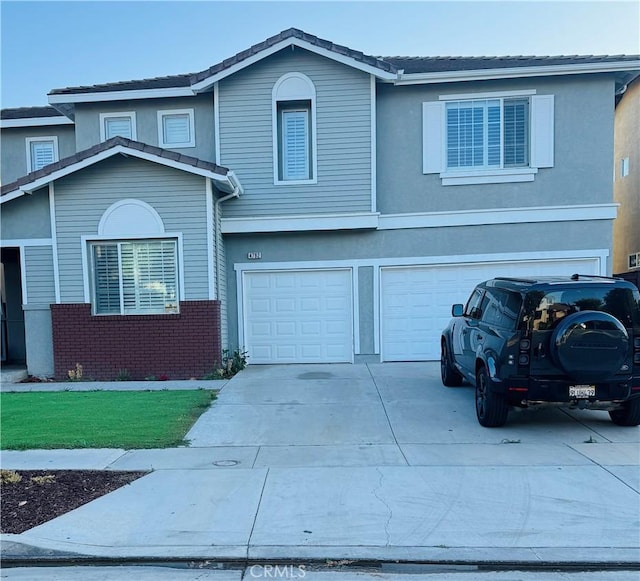 4792 Parkscape Dr, Riverside, CA 92505 - view of front facade with a garage, concrete driveway, brick siding, and stucco siding