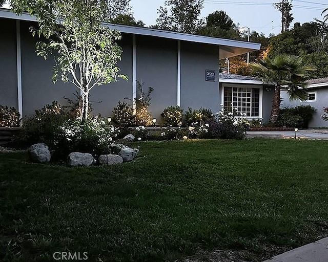 26261 Veva Way, Calabasas, CA 91302 - view of home's exterior featuring a lawn and stucco siding