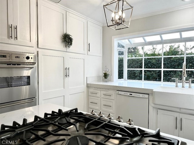 26261 Veva Way, Calabasas, CA 91302 - kitchen featuring stainless steel appliances, ornamental molding, white cabinetry, a chandelier, and healthy amount of natural light