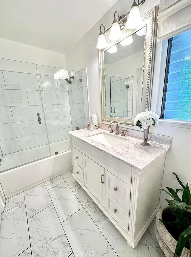 26261 Veva Way, Calabasas, CA 91302 - bathroom featuring marble look tile flooring, vanity, and bath / shower combo with glass door