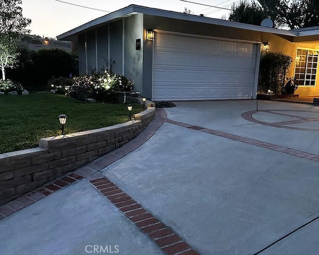 26261 Veva Way, Calabasas, CA 91302 - view of home's exterior featuring driveway, a garage, a lawn, and stucco siding