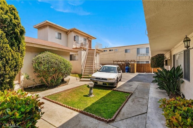 1900 Vanderbilt Ln, Redondo Beach, CA 90278 - view of front facade with stairway, stucco siding, and uncovered parking