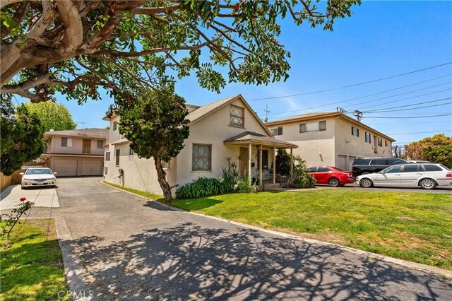 1900 Vanderbilt Ln, Redondo Beach, CA 90278 - view of front facade with stucco siding, a front yard, and driveway