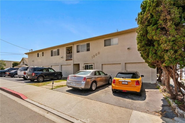 1900 Vanderbilt Ln, Redondo Beach, CA 90278 - view of front of property with an attached garage, stucco siding, and driveway