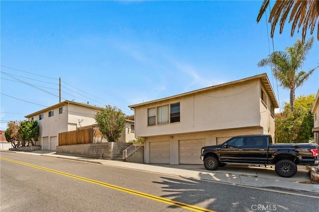1900 Vanderbilt Ln, Redondo Beach, CA 90278 - view of front of property with stucco siding and an attached garage
