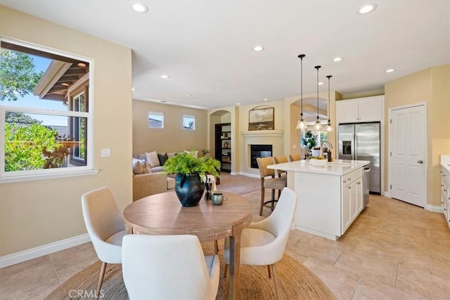 839 Chukar St, Arroyo Grande, CA 93420 - dining room with a glass covered fireplace, recessed lighting, and light tile patterned floors
