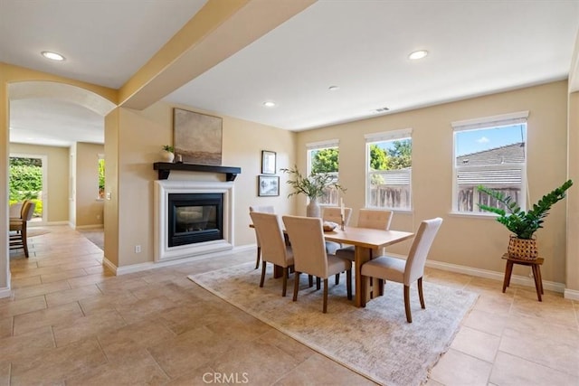 839 Chukar St, Arroyo Grande, CA 93420 - dining room with arched walkways, healthy amount of natural light, a glass covered fireplace, recessed lighting, and light tile patterned floors