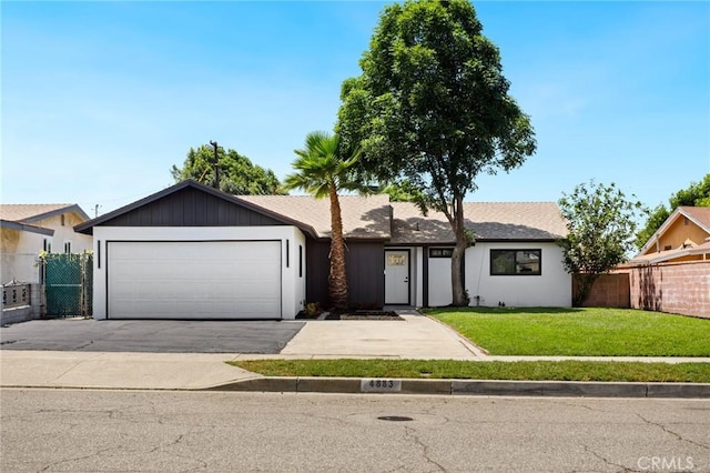 4883 Harvard St, Montclair, CA 91763 - view of front of home with driveway and an attached garage