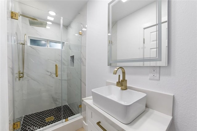 4883 Harvard St, Montclair, CA 91763 - bathroom with vanity, a marble finish shower, and a textured wall