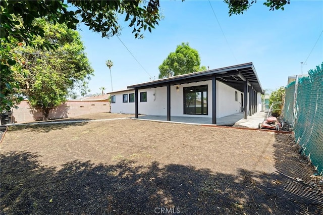 4883 Harvard St, Montclair, CA 91763 - rear view of property featuring a fenced backyard, stucco siding, and a patio area