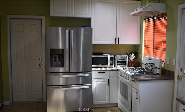 356 S S St, Rialto, CA 92376 - kitchen featuring appliances with stainless steel finishes, under cabinet range hood, light tile patterned floors, and white cabinetry