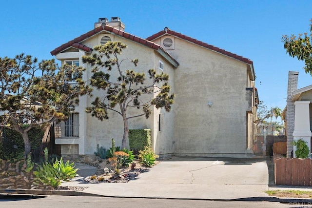 4525 Mississippi St Unit 2, San Diego, CA 92116 - view of front of property featuring a chimney, a tile roof, and stucco siding