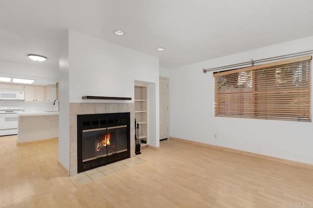4525 Mississippi St Unit 2, San Diego, CA 92116 - unfurnished living room with light wood-style flooring, a fireplace, and recessed lighting