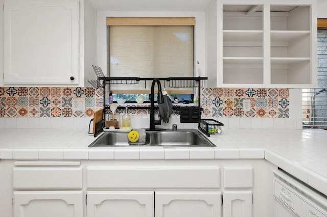4525 Mississippi St Unit 2, San Diego, CA 92116 - kitchen with white dishwasher, white cabinetry, backsplash, and tile counters