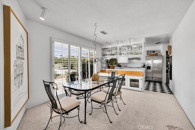 54832 Benecia Trl, Yucca Valley, CA 92284 - dining space featuring a textured ceiling and light carpet