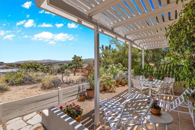 54832 Benecia Trl, Yucca Valley, CA 92284 - view of patio with outdoor dining area, a pergola, and a mountain view