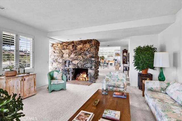 54832 Benecia Trl, Yucca Valley, CA 92284 - living area featuring carpet floors, a textured ceiling, and a stone fireplace