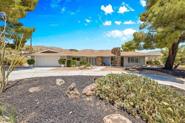 54832 Benecia Trl, Yucca Valley, CA 92284 - ranch-style house with concrete driveway, an attached garage, and stucco siding