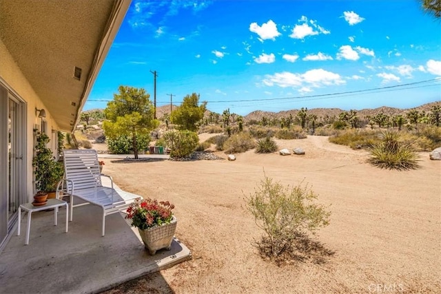54832 Benecia Trl, Yucca Valley, CA 92284 - view of yard with a patio area and a mountain view