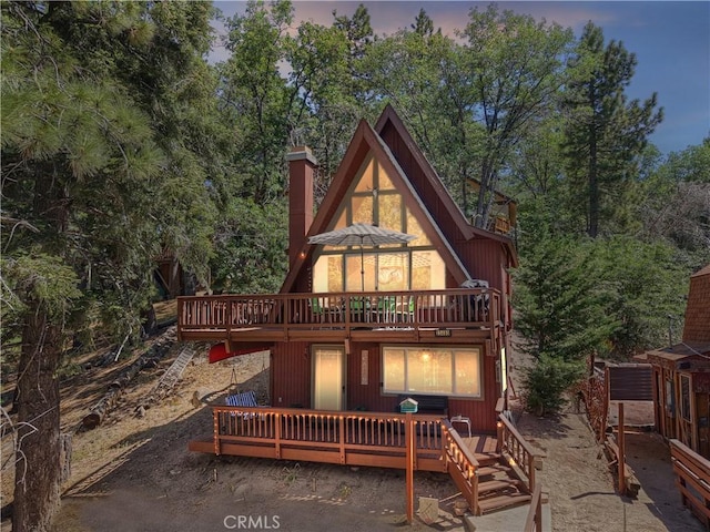 33480 Weeping Willow Dr, Green Valley Lake, CA 92341 - back of house at dusk with a chimney and a deck