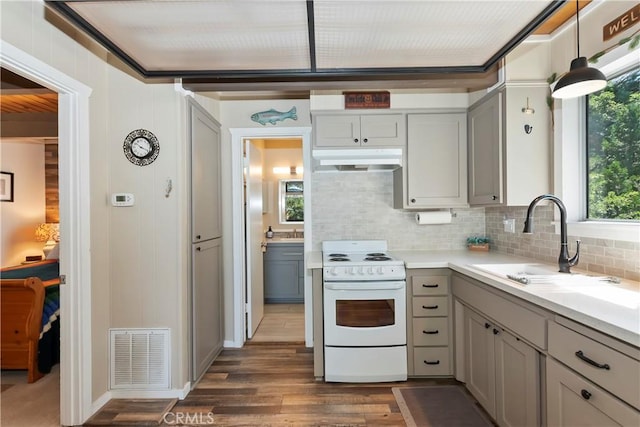 33480 Weeping Willow Dr, Green Valley Lake, CA 92341 - kitchen with white range with electric stovetop, under cabinet range hood, tasteful backsplash, and gray cabinets
