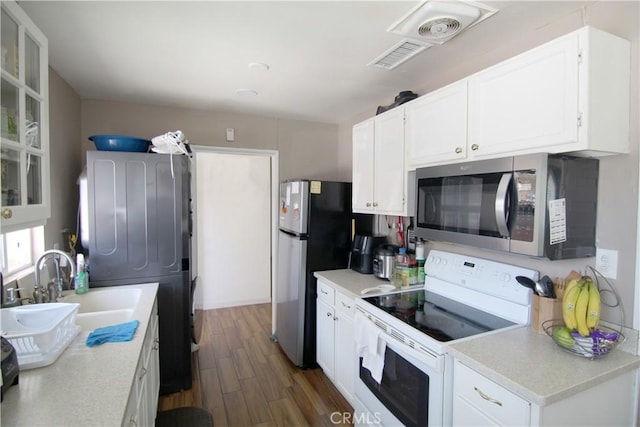 5631 Walter St, Riverside, CA 92504 - kitchen with stainless steel appliances, dark wood-style flooring, white cabinets, light countertops, and glass insert cabinets
