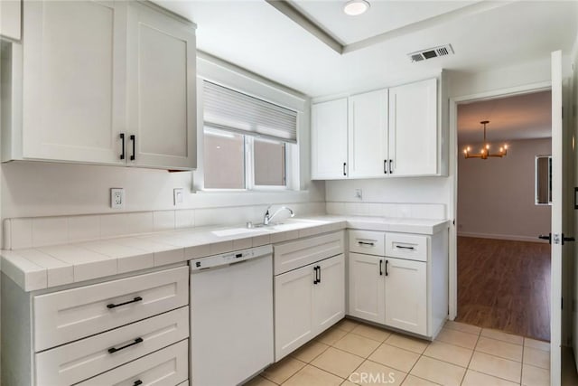2343 Navarro Dr, Claremont, CA 91711 - kitchen with white dishwasher, tile countertops, white cabinetry, a chandelier, and light tile patterned flooring