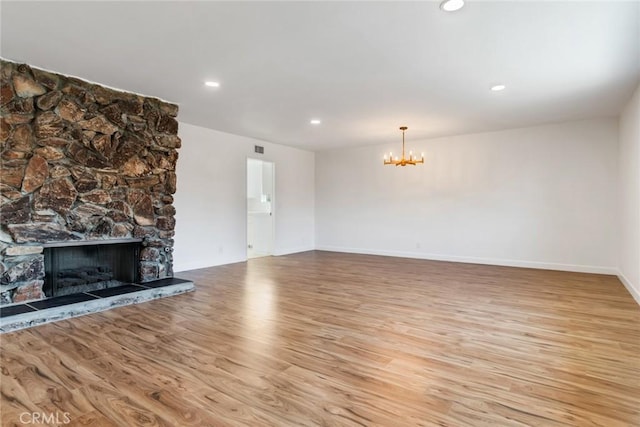 2343 Navarro Dr, Claremont, CA 91711 - unfurnished living room with a chandelier, light wood-style floors, a stone fireplace, and recessed lighting