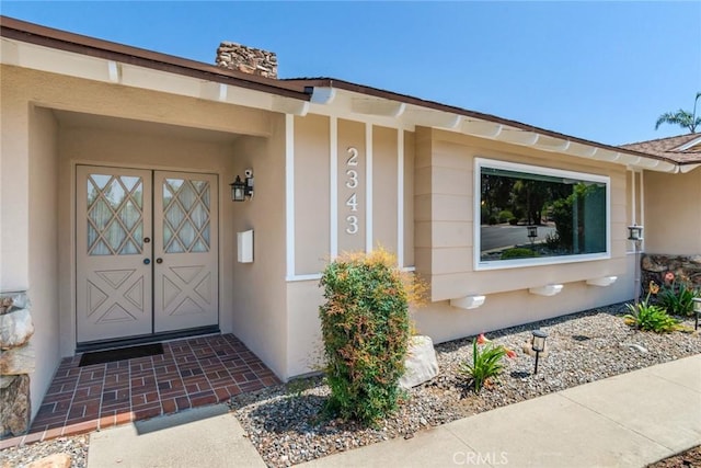 2343 Navarro Dr, Claremont, CA 91711 - view of exterior entry with stucco siding and a chimney